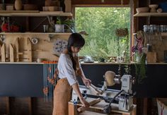 a woman is working in a wood shop