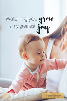 a woman holding a baby in her lap with the caption watching you grow is my greatest joy