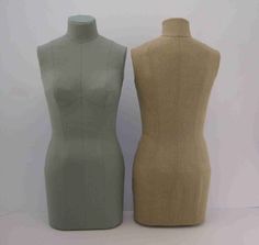 two mannequins are standing next to each other on a white tablecloth