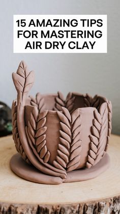 an air dry clay vase sitting on top of a tree stump with the words, 15 amazing tips for mastering air dry clay