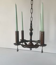 a chandelier with four candles hanging from it