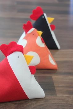 three little chicken bean bags sitting on top of a wooden table