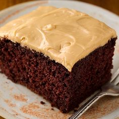 a piece of chocolate cake with frosting on a plate