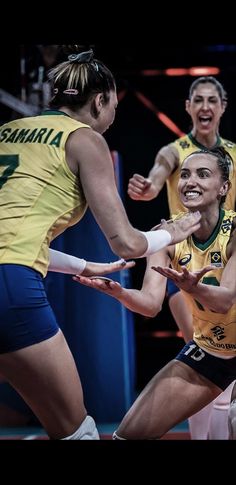 two women are playing volleyball with each other