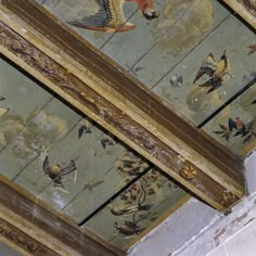 the ceiling is painted with birds and flowers