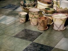 many different pots are sitting on the floor