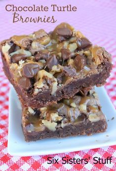 two brownies are stacked on top of each other with chocolate chips and walnuts