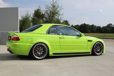 a bright green car parked in front of a building