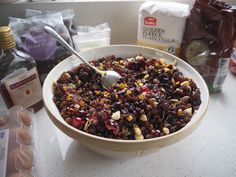 a bowl filled with fruit and nuts on top of a counter