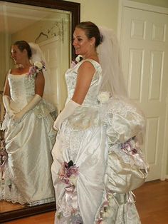 the bride is looking at herself in the mirror