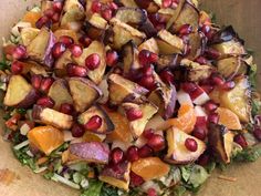 a salad with pomegranate, oranges and other vegetables