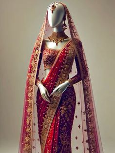 a mannequin wearing a red and gold sari