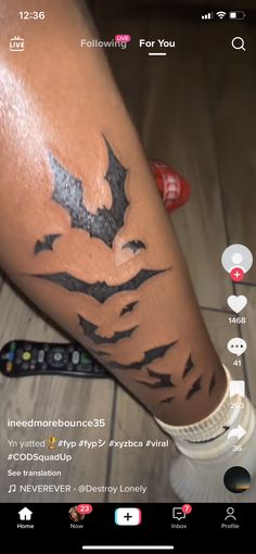 a person with a bat tattoo on their leg next to a remote control and the text below it reads follow me for you