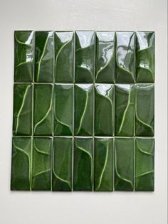 a green tile with many different shapes and sizes