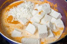 tofu and cheese are mixed together in a bowl