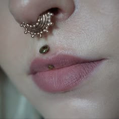 a close up of a person's nose with a piercing on top of it