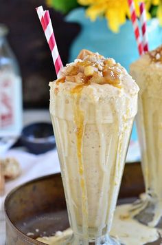 two glasses filled with ice cream sitting on top of a table