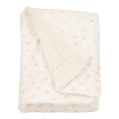 a white blanket with pink polka dots on it