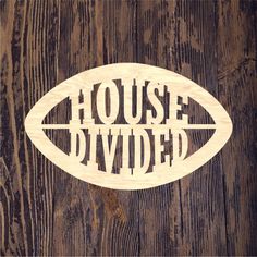 a wooden sign that says house divided on top of a wood planked wall with the word'house divided'carved into it