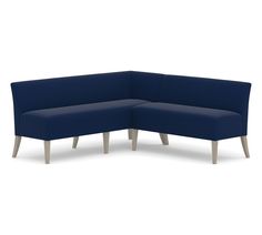 a blue sectional couch with wooden legs