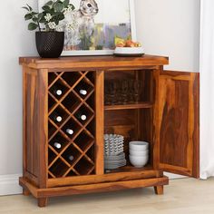 a wooden cabinet with wine bottles and glasses