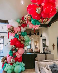 a bunch of balloons that are in the shape of a tower on top of a couch