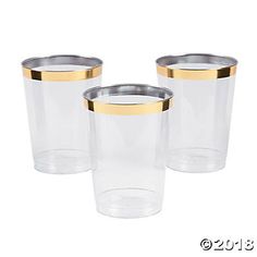 three clear glass cups with gold rims