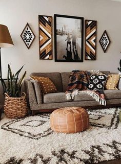 a living room filled with lots of furniture and pictures on the wall above it's couch