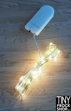 a light that is on top of a wooden floor next to a hair dryer