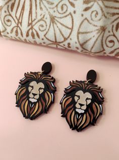 Make a statement in your jewelry game with these Lion Drop Earrings.  These eco-friendly wooden earrings are perfect for animal lovers and zodiac enthusiasts alike.  The lion design is delicate yet makes a bold statement.  These Lion Earrings are the perfect gift for her and will add a chic touch to any outfit.  Get ready to wow everyone around you with these one-of-a-kind Lion Statement Earrings.  Order now and give your accessory collection that much-needed upgrade. This item is handcrafted & Zodiac Earrings, Lion Earrings, Laser Cut Earrings, Great Gifts For Women, Polymer Clay Charms, Clay Charms, Wooden Earrings, Light Weight Earrings, Polymer Clay Crafts