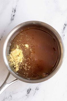 a pot filled with brown liquid and spices