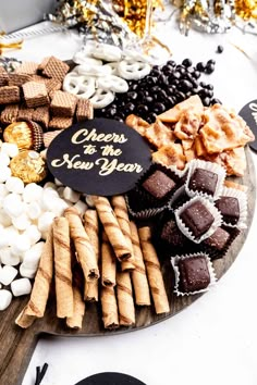 a platter filled with different types of snacks and desserts on top of a table