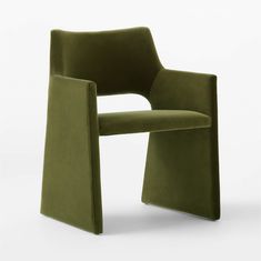 a green chair sitting on top of a white floor