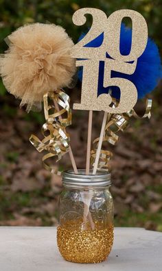 a mason jar filled with gold and blue decorations