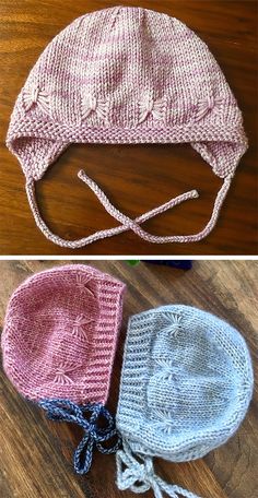 two knitted hats sitting on top of a wooden floor