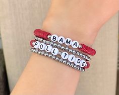 two red and white beaded bracelets with the word obama written on each one