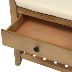 a wooden bench with a cushion on the top and bottom drawer open to show its contents