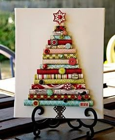 a card with a christmas tree made out of different types of fabric and buttons on it