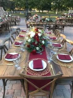 a table set with red napkins and place settings