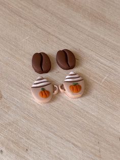 two chocolate covered cupcakes sitting on top of a wooden table