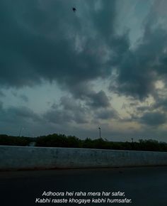 an airplane is flying in the sky with dark clouds