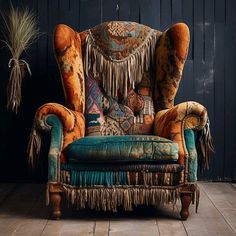 an old chair with fringes and pillows on it