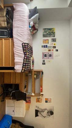 a bed sitting on top of a wooden shelf