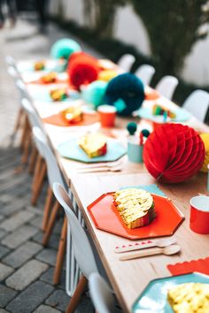 a long table with plates and cups on it