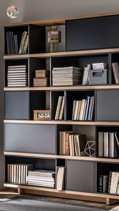 a bookshelf filled with lots of books in a room