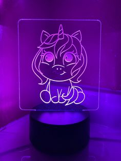 an illuminated lamp with a cartoon character on it's face in the middle of a purple background