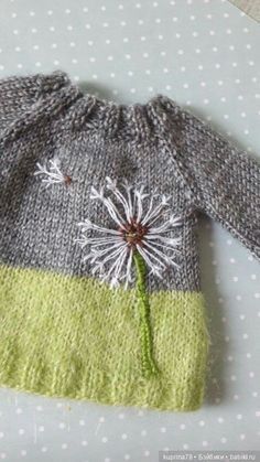 a knitted sweater with a dandelion on it