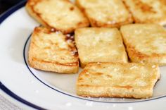 there are crackers on the plate and one has been cut into small cubes