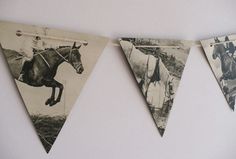 three pennants with horses on them hanging from the wall