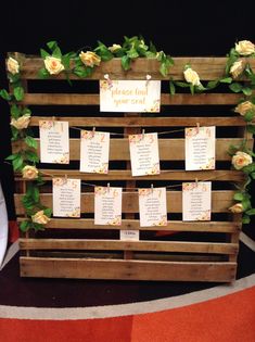 a wooden pallet with flowers and notes attached to it